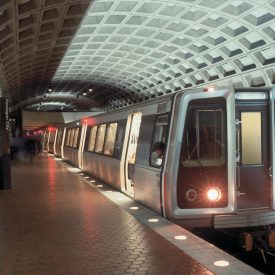 A photographic image of a metro-rail passenger train parked at the station.