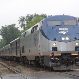 A photographic image of an Amtrak train approaching.
