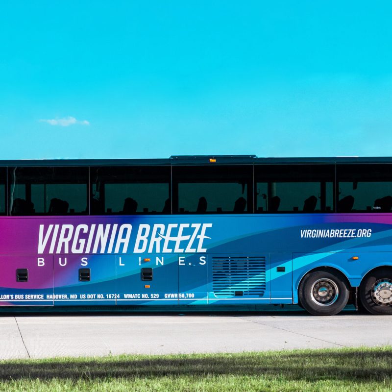 A photographic image of a Virginia Breeze Bus Lines bus parked with a clear, blue sky background.