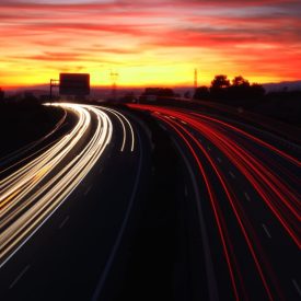A stock photographic image of a busy highway at night.